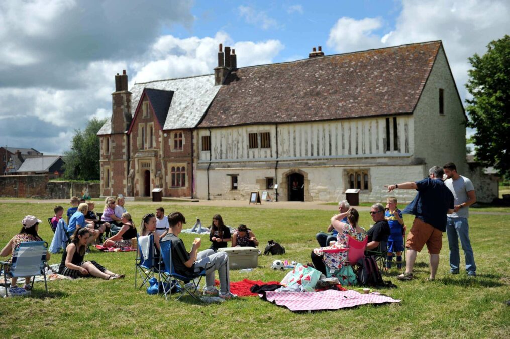 Families enjoying a picnic in the grounds of Llanthony Secunda Priory