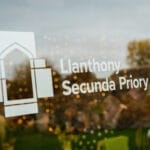 Reflection of the trees in a branded window at Llanthony Secunda Priory