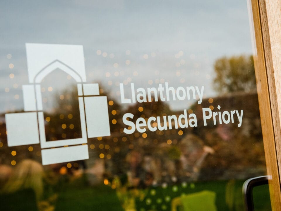 Reflection of the trees in a branded window at Llanthony Secunda Priory